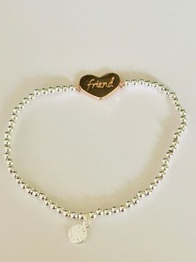 Katie Loxton beaded stretch bracelet featuring two-tones, heart “friend” charm